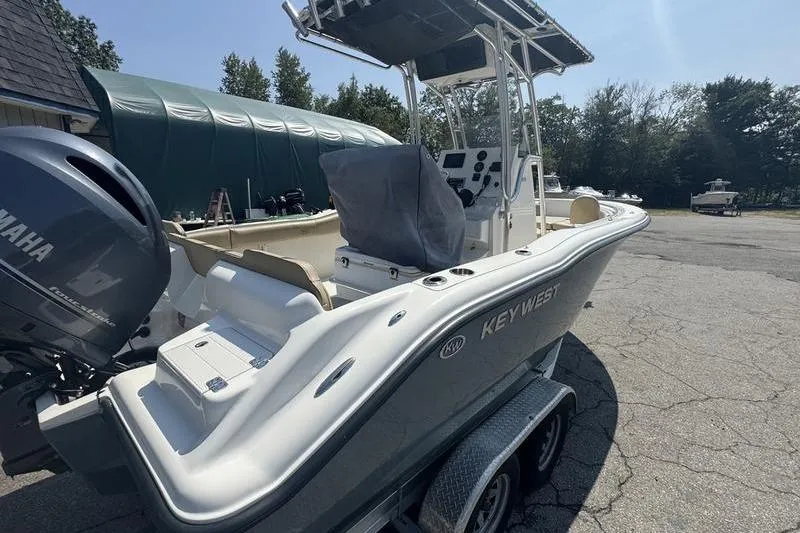 Slide: The Image of 2019 Key West 219fs boat with Yamaha engine on trailer, parked outdoors. - 5