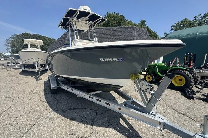 Slide: The Image of 2019 Key West 219fs boat on trailer, parked outdoors under clear sky. - 7