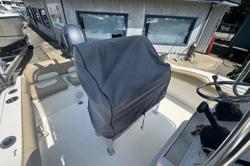 Slide: The Image of 2019 Key West 219fs boat interior with covered console and steering wheel. - 8