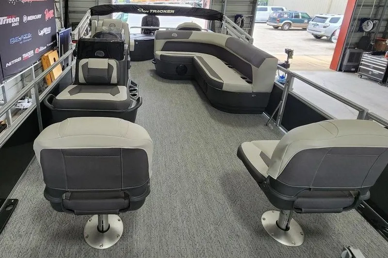 Slide: The Image of 2026 Sun Tracker BASS BUGGY® 18 DLX pontoon boat interior with gray seating and spacious layout. - 11