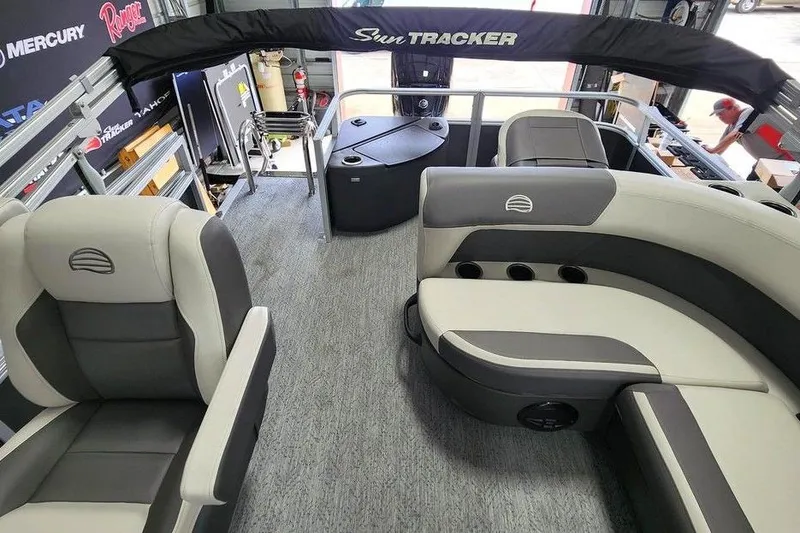 Slide: The Image of 2026 Sun Tracker BASS BUGGY® 18 DLX interior with gray seating and carpeted flooring. - 12