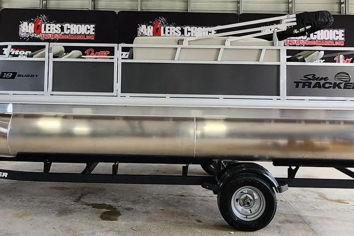 Slide: The Image of 2026 Sun Tracker BASS BUGGY® 18 DLX pontoon boat on trailer in showroom. - 5