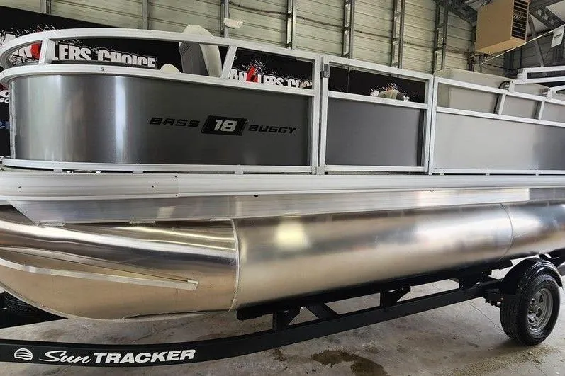 Slide: The Image of 2026 Sun Tracker BASS BUGGY® 18 DLX pontoon boat in a showroom. - 7