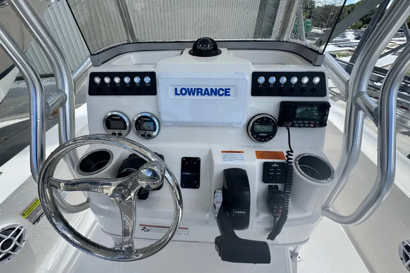Slide: The Image of 2022 Robalo 206 Cayman boat dashboard with steering wheel and Lowrance electronics. - 12