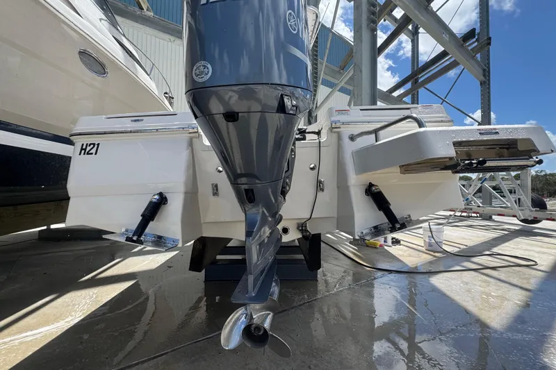 Slide: The Image of 2022 Robalo 206 Cayman boat with Yamaha outboard motor, docked on a sunny day. - 18