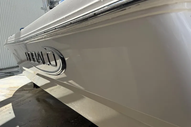 Slide: The Image of 2022 Robalo 206 Cayman boat side view with logo in sunlight. - 19