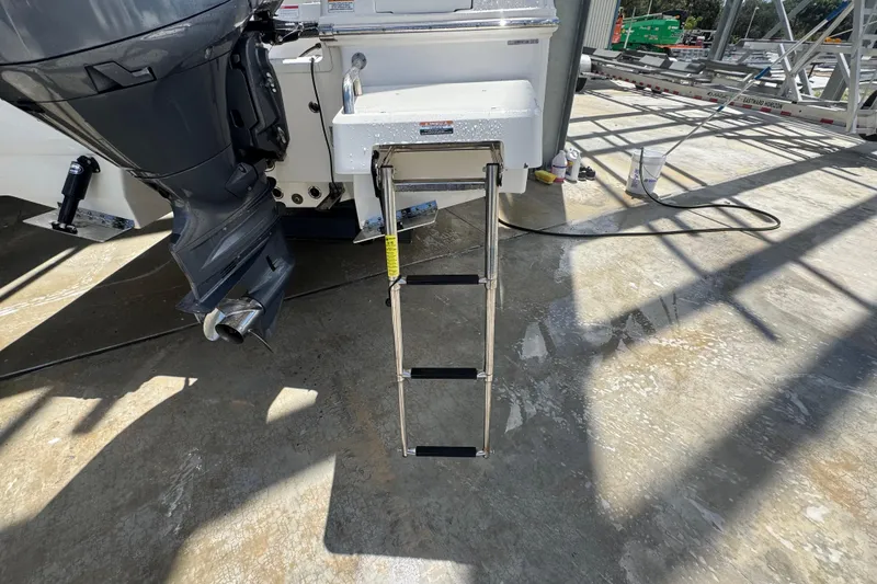 Slide: The Image of 2022 Robalo 206 Cayman boat with extended swim ladder and outboard motor. - 20