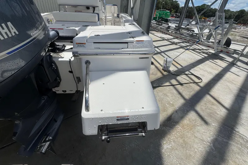 Slide: The Image of 2022 Robalo 206 Cayman boat with Yamaha outboard motor, docked on concrete surface. - 21