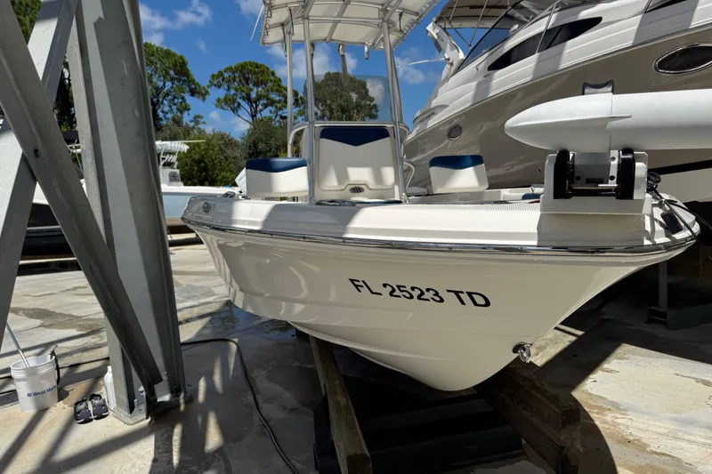 Slide: The Image of 2022 Robalo 206 Cayman boat docked, featuring sleek design and modern equipment. - 22