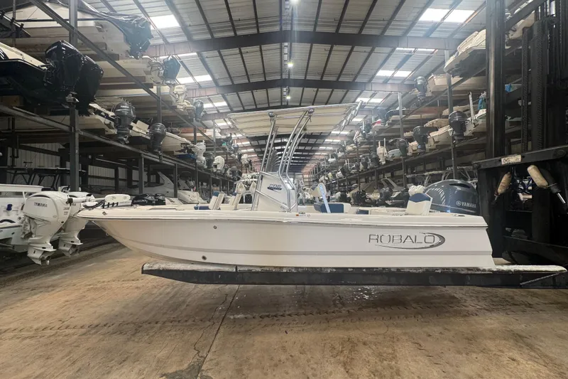Slide: The Image of 2022 Robalo 206 Cayman boat in storage facility with multiple boats. - 5
