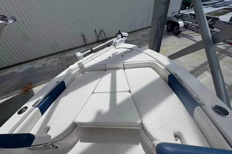 Slide: The Image of 2022 Robalo 206 Cayman boat interior with cushioned seating and fishing equipment. - 7