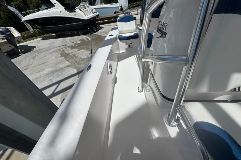 Slide: The Image of 2022 Robalo 206 Cayman boat interior with sleek white deck and seating. - 8