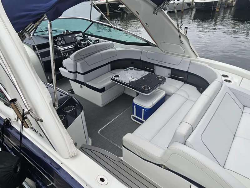 Slide: The Image of 2018 Formula 350 Sun Sport boat with spacious seating and modern interior at a marina. - 15