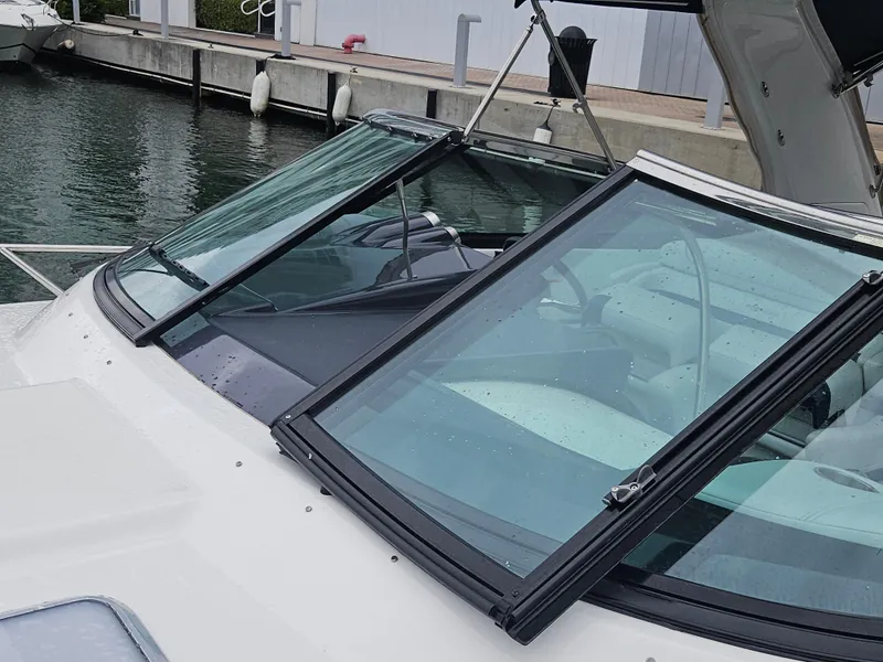 Slide: The Image of 2018 Formula 350 Sun Sport boat docked, close-up of windshield and cockpit area. - 2