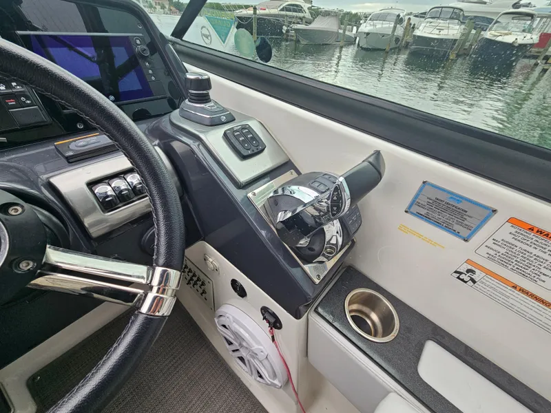 Slide: The Image of 2018 Formula 350 Sun Sport helm with controls and marina view. - 24