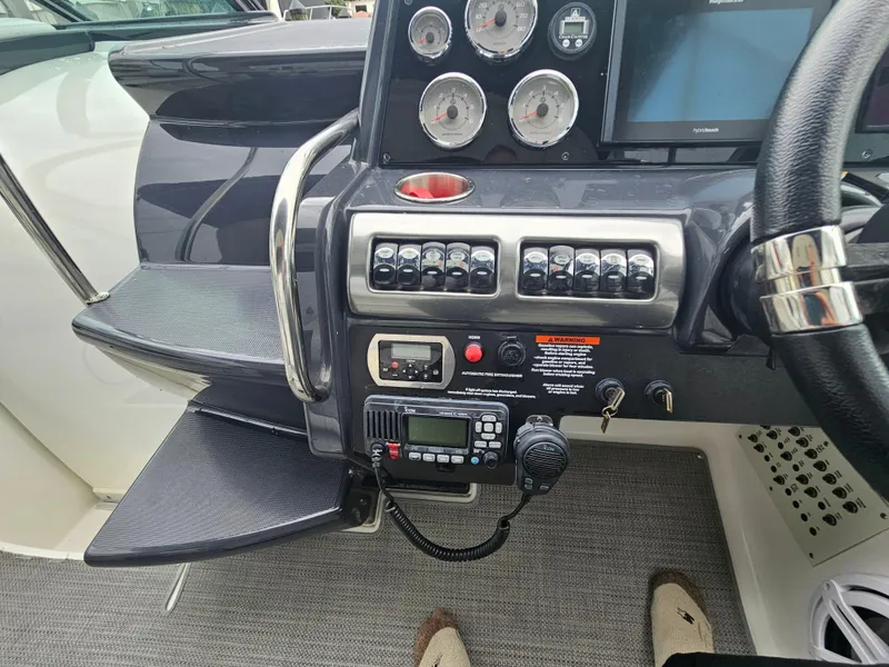 Slide: The Image of Control panel of a 2018 Formula 350 Sun Sport boat with gauges and radio equipment. - 26