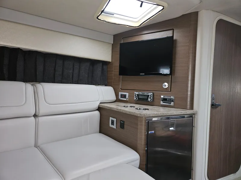 Slide: The Image of 2018 Formula 350 Sun Sport cabin interior with TV, seating, and mini fridge. - 46