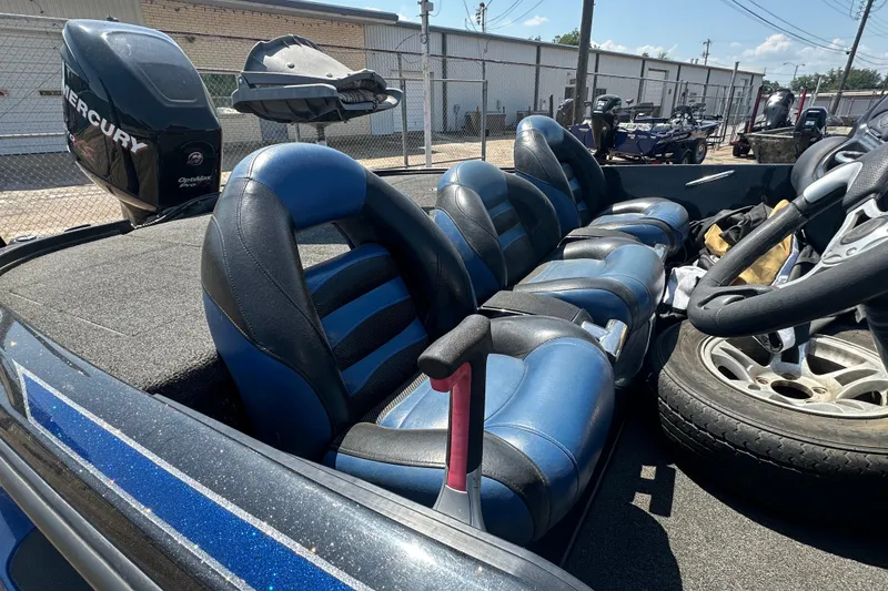 Slide: The Image of Interior of a 2012 Nitro Z-9 boat with blue and black seating. - 11