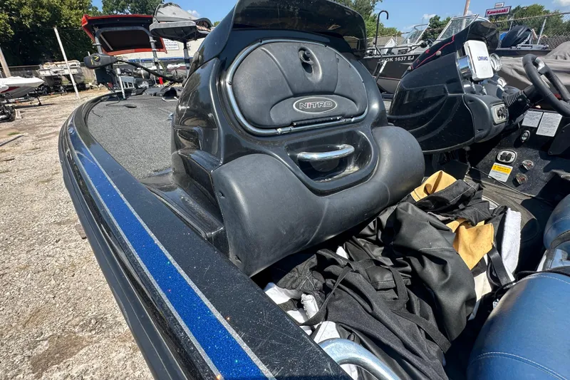 Slide: The Image of 2012 Nitro Z-9 boat interior with storage compartments and seating, parked outdoors. - 14