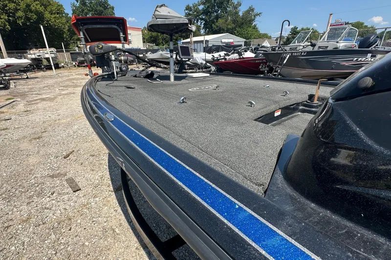 Slide: The Image of 2012 Nitro Z-9 boat with blue stripe, parked outdoors on gravel. - 15