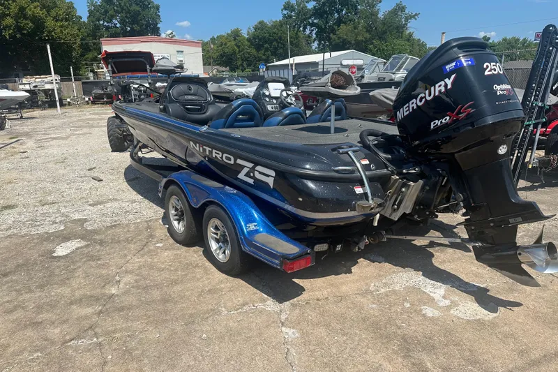 Slide: The Image of 2012 Nitro Z-9 boat with Mercury Pro XS engine on trailer in outdoor setting. - 2