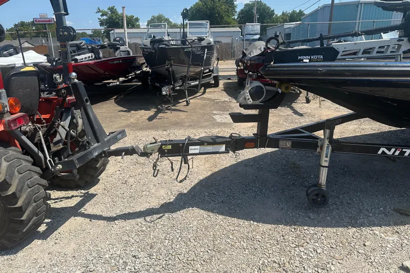 Slide: The Image of Tractor towing a 2012 Nitro Z-9 boat trailer in a gravel lot. - 6