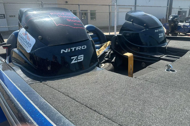 Slide: The Image of 2012 Nitro Z-9 boat engines on a trailer, parked outdoors. - 8