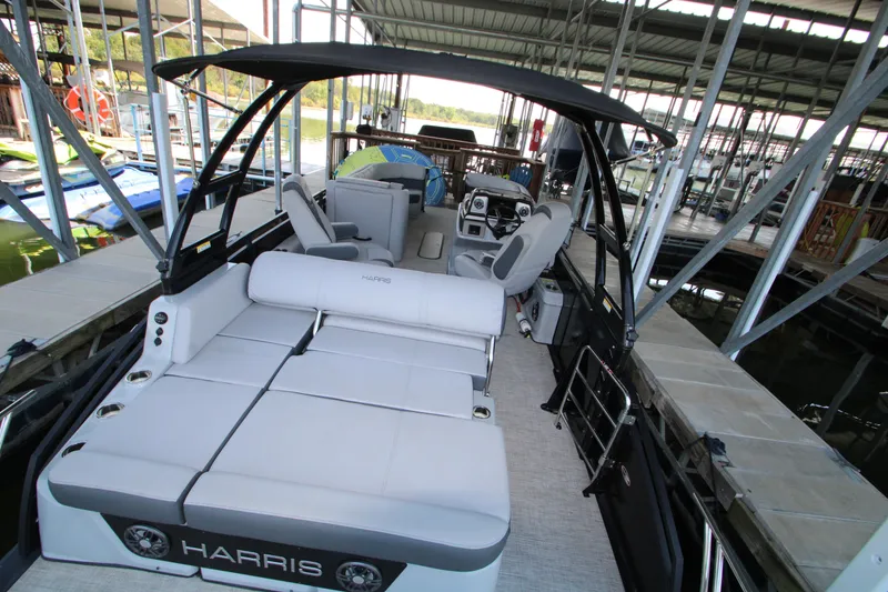 Slide: The Image of 2020 Harris FloteBote Solstice 250 SL pontoon boat docked under a covered marina. - 16
