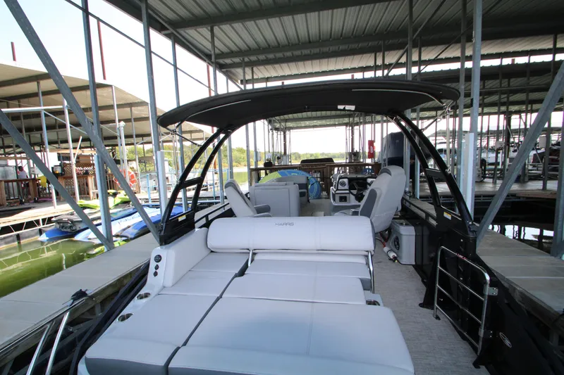 Slide: The Image of 2020 Harris FloteBote Solstice 250 SL pontoon boat docked under covered marina. - 17
