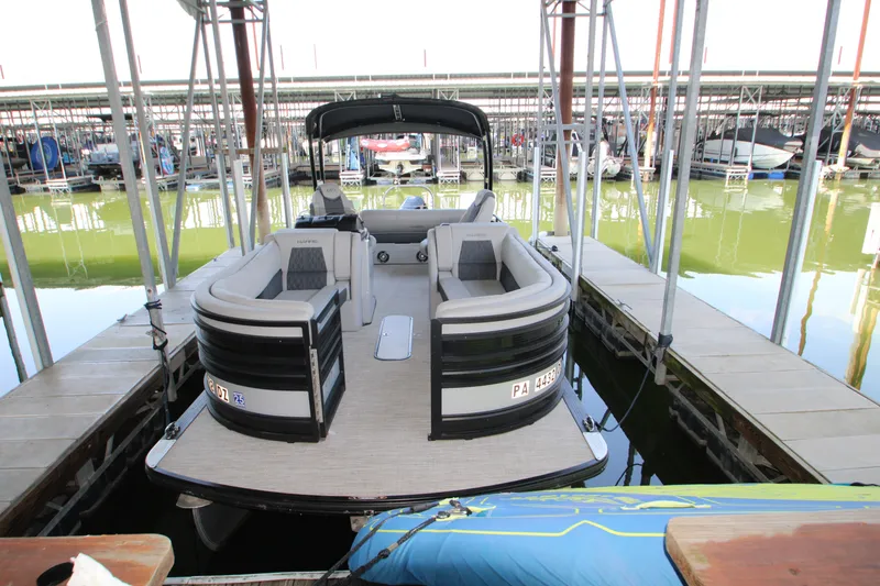 Slide: The Image of 2020 Harris FloteBote Solstice 250 SL pontoon boat docked in marina. - 2