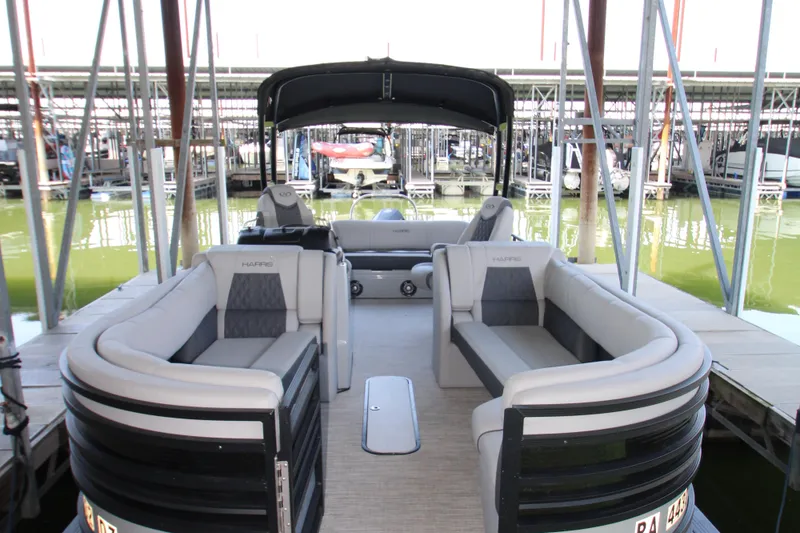 Slide: The Image of 2020 Harris FloteBote Solstice 250 SL pontoon boat docked, featuring spacious seating. - 3