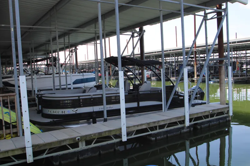 Slide: The Image of 2020 Harris FloteBote Solstice 250 SL pontoon boat docked in a marina. - 34