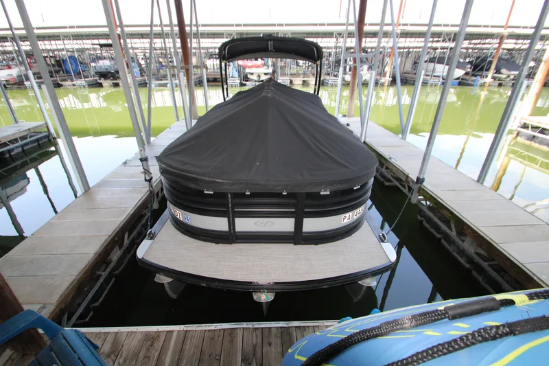 Slide: The Image of 2020 Harris FloteBote Solstice 250 SL pontoon boat docked with cover. - 40