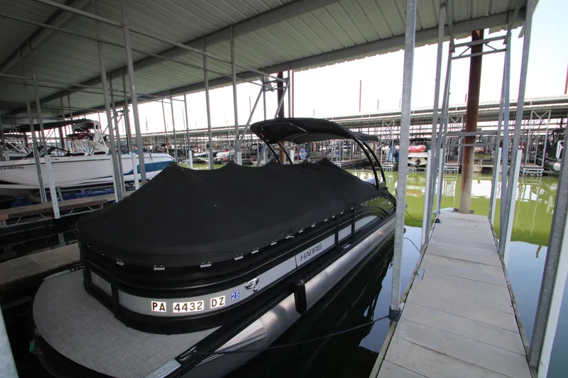 Slide: The Image of 2020 Harris FloteBote Solstice 250 SL pontoon boat docked under a covered marina. - 41