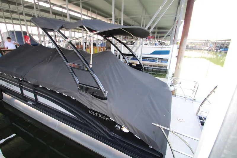 Slide: The Image of 2020 Harris FloteBote Solstice 250 SL pontoon boat docked under a covered marina. - 42