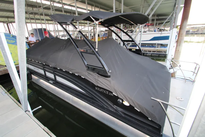 Slide: The Image of 2020 Harris FloteBote Solstice 250 SL pontoon boat docked with cover. - 43