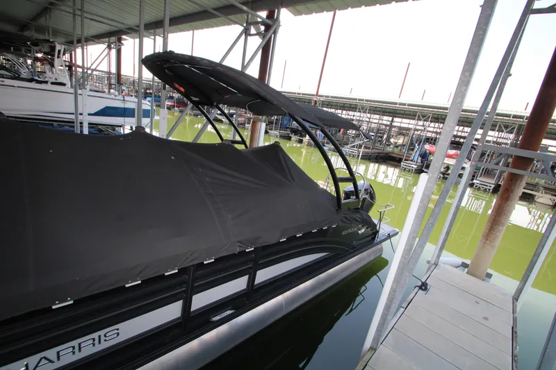 Slide: The Image of 2020 Harris FloteBote Solstice 250 SL pontoon boat docked under cover. - 44