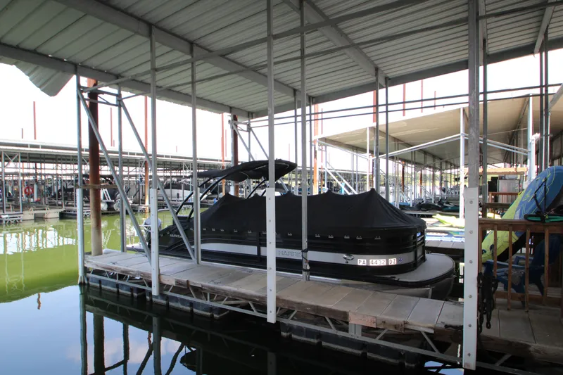 Slide: The Image of 2020 Harris FloteBote Solstice 250 SL pontoon boat docked under covered marina. - 47
