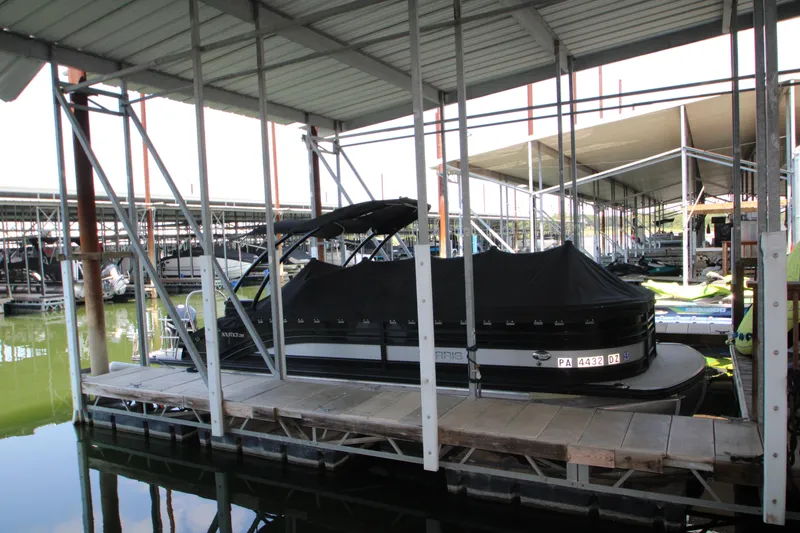 Slide: The Image of 2020 Harris FloteBote Solstice 250 SL pontoon boat docked under covered marina. - 48
