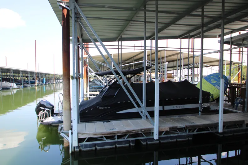 Slide: The Image of 2020 Harris FloteBote Solstice 250 SL pontoon boat docked in a marina. - 49