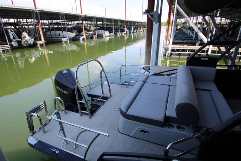 Slide: The Image of 2020 Harris FloteBote Solstice 250 SL pontoon boat docked in marina, featuring Mercury engine. - 7