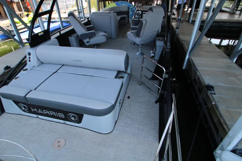 Slide: The Image of 2020 Harris FloteBote Solstice 250 SL pontoon boat interior with seating and dock view. - 8