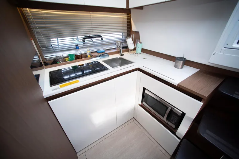 Slide: The Image of Compact kitchen in a 2017 Jeanneau Leader 40 yacht, featuring modern appliances and sleek design. - 34