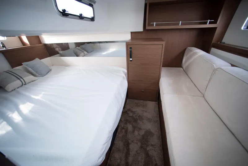 Slide: The Image of 2017 Jeanneau Leader 40 cabin interior with bed, sofa, and wooden cabinetry. - 39