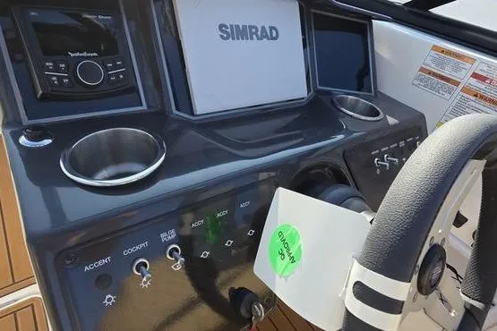 Slide: The Image of 2025 Bayliner VR5 OB boat dashboard with Simrad display and control panel. - 10