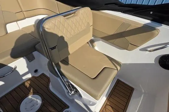 Slide: The Image of 2025 Bayliner VR5 OB boat interior with tan seating and wood-style flooring. - 13