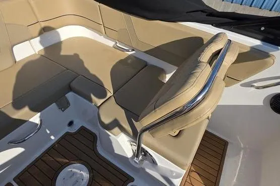 Slide: The Image of 2025 Bayliner VR5 OB boat interior with tan seating and wood flooring. - 14