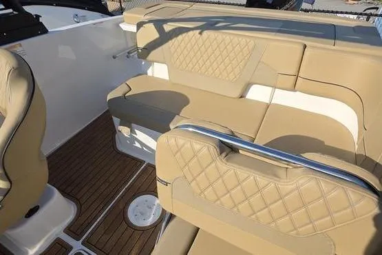 Slide: The Image of 2025 Bayliner VR5 OB boat interior with tan leather seating and wood flooring. - 15