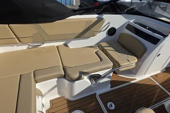 Slide: The Image of 2025 Bayliner VR5 OB boat interior with tan seating and wood flooring. - 16