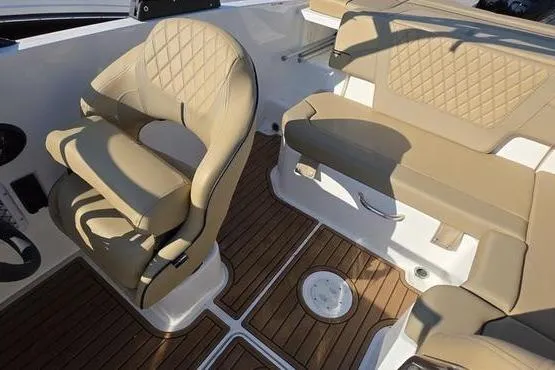 Slide: The Image of 2025 Bayliner VR5 OB boat interior with tan seating and wood-style flooring. - 18